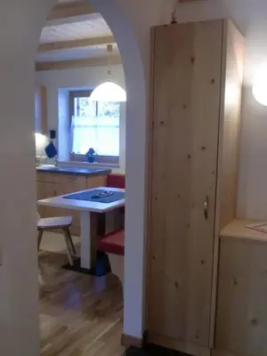 a kitchen with a table and a table and a door at Winterklaubhof in Siusi
