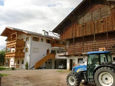 a tractor parked in front of a building at Winterklaubhof in Siusi