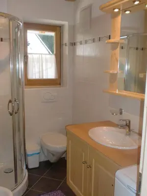 a bathroom with a sink and a toilet and a window at Winterklaubhof in Siusi