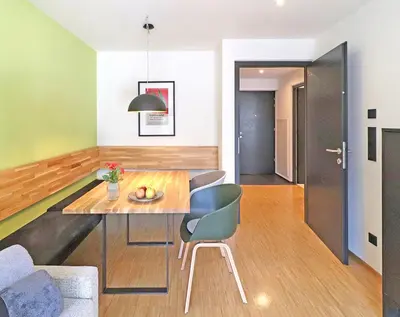 a dining room and living room with a table and chairs at Apartment Luis 1 - Alpstay in Naturno