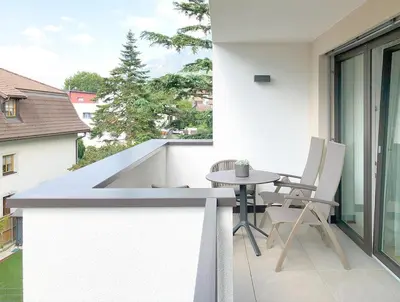 a patio with a table and chairs on a balcony at Apartment Luis 1 - Alpstay in Naturno