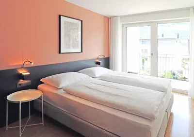 a bedroom with two beds and a table and a window at Apartment Luis 1 - Alpstay in Naturno