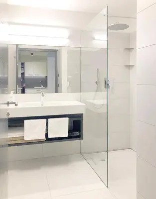 a white bathroom with a sink and a shower at Apartment Luis 1 - Alpstay in Naturno