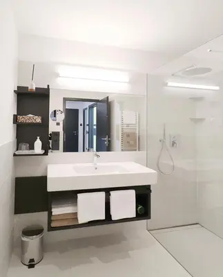 a white bathroom with a sink and a shower at Apartment Luis 1 - Alpstay in Naturno