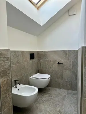 a bathroom with a white toilet and a sink at Wieserhof Family Farm in Maranza