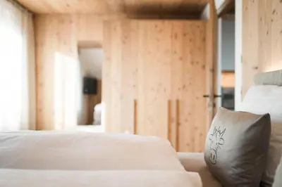 a bedroom with a bed with a pillow on it at Wieserhof Family Farm in Maranza