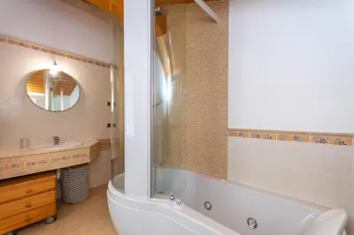 a bathroom with a tub and a toilet and a sink at La Casa di Elvira-Mansarda in Alleghe
