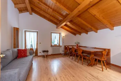 a living room with a couch and a table at La Casa di Elvira-Mansarda in Alleghe