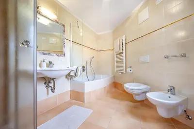 a bathroom with a sink and a toilet and a shower at Apartments Ciancel Gino in Ortisei