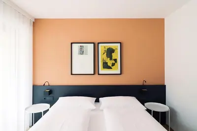 a bedroom with two white beds and two chairs at Apartment Luis 3 - Alpstay in Naturno