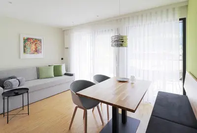 a living room with a table and chairs and a couch at Apartment Luis 3 - Alpstay in Naturno