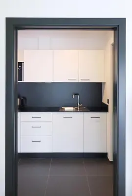 a kitchen with white cabinets and a sink at Apartment Luis 3 - Alpstay in Naturno