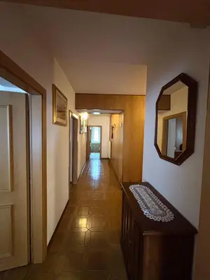 a hallway of a hotel with a mirror on the wall at Appartamento di Nina in Moena