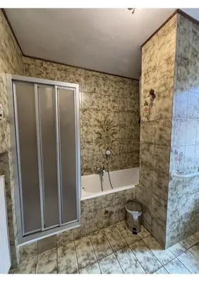 a bathroom with a shower and a tub at Appartamento di Nina in Moena