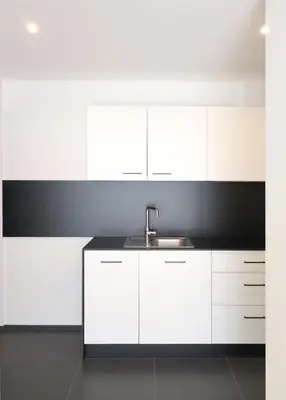 a kitchen with white cabinets and a sink at Apartment Luis 4 - Alpstay in Naturno