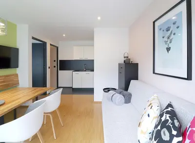 a living room and kitchen with a couch and a table at Apartment Luis 4 - Alpstay in Naturno