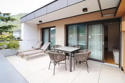 a patio with a table and chairs on a balcony at Apartment Luis 4 - Alpstay in Naturno