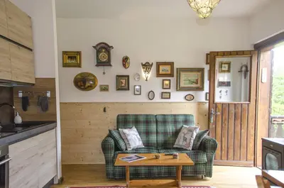 a living room with a couch and a table at Casa Salvaniera in San Vito di Cadore