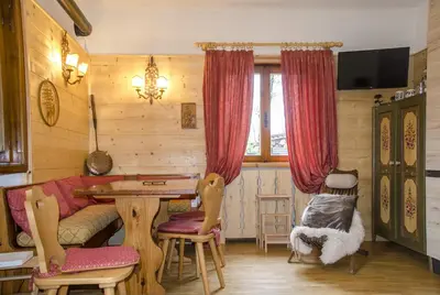 a living room with a couch and a table at Casa Salvaniera in San Vito di Cadore