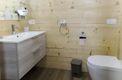 a bathroom with a toilet and a sink at Casa Salvaniera in San Vito di Cadore