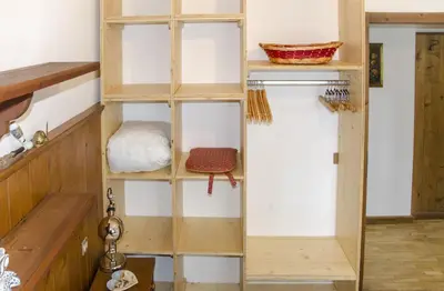 a wooden shelving unit in a room at Casa Salvaniera in San Vito di Cadore
