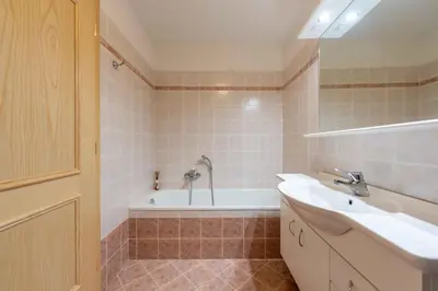 a bathroom with a sink and a bath tub at Cesa Masè in Pozza di Fassa