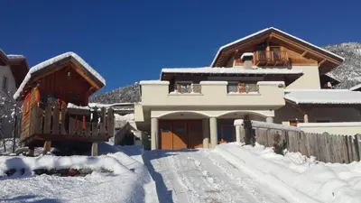 a house covered in snow with a fence at Horse House in Romallo