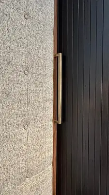 a door in a room with a wooden wall at VILLAREJA - Panorama Penthouse Suite mit Blick auf die Dolomiten in Bolzano