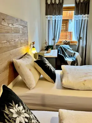 a bedroom with two beds with pillows on it at Antler Apartment in Santa Fosca