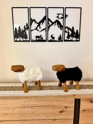 two dogs sitting on a table in front of paintings at Antler Apartment in Santa Fosca