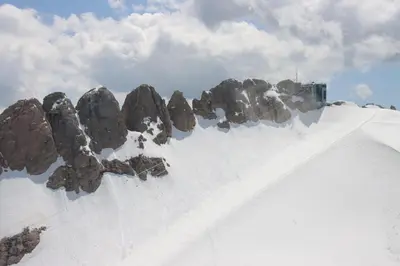 a pile of rocks on top of a snow covered mountain at Silentium Dolomites Chalet in Monguelfo