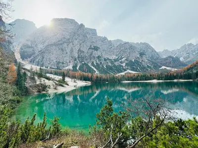 a view of a lake with mountains in the background at Silentium Dolomites Chalet in Monguelfo