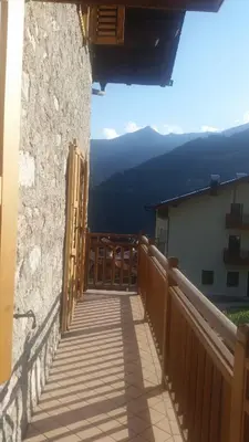 a balcony of a building with a view of the mountains at Casa Danoli in Canale San Bovo