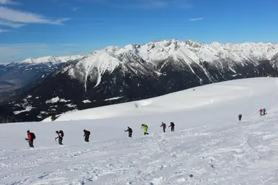 a group of people skiing down a snow covered mountain at Casa Danoli in Canale San Bovo