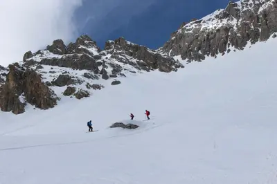 three people are skiing down a snow covered mountain at Casa Danoli in Canale San Bovo