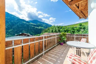 a kitchen and living room with a table and chairs at Residence Chalet Riad in Saltusio