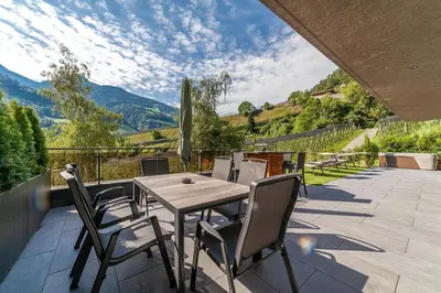 a living room with a couch and a table at Residence Chalet Riad in Saltusio