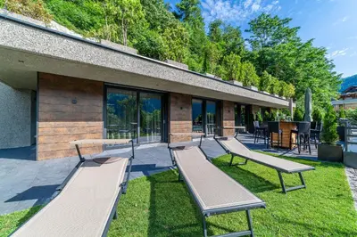 a row of benches sitting outside of a building at Residence Chalet Riad in Saltusio