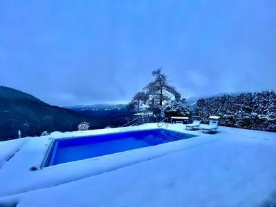 a swimming pool covered in snow on the roof of a house at Oberprantschöllhof - Horse Mountain Stable in Bressanone