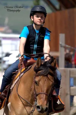 a woman riding on the back of a horse at Oberprantschöllhof - Horse Mountain Stable in Bressanone