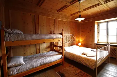 a bedroom with two bunk beds in a cabin at Casa Nido sul Cermis in Varena
