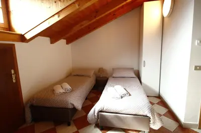 a room with two beds in a room at Casa Nido sul Cermis in Varena
