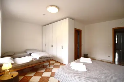 a bedroom with two beds and a cabinet at Casa Nido sul Cermis in Varena