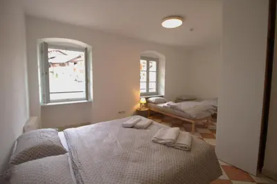 a white bedroom with two towels on a bed at Casa Nido sul Cermis in Varena