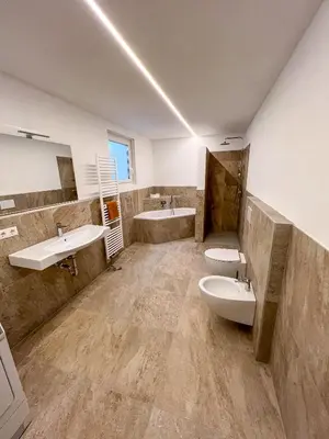 a bathroom with two sinks and two toilets at Villa Moos Appartement in Colle Isarco
