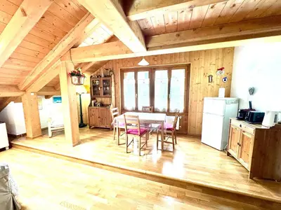 a kitchen and dining room with a table and a refrigerator at Ciasa De Cin - 10 minutes from Cortina in San Vito di Cadore