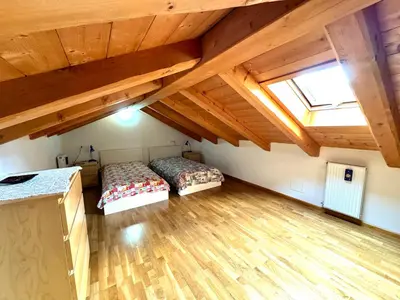 a bedroom with two beds in a attic at Ciasa De Cin - 10 minutes from Cortina in San Vito di Cadore