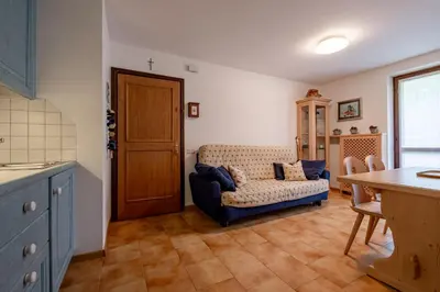 a living room with a couch and a table at Casa Lugli by go new location in Cavalese