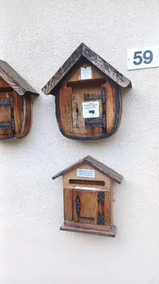 a wall with three bird houses on it at Mansarda Ai Tigli in Castello di Fiemme