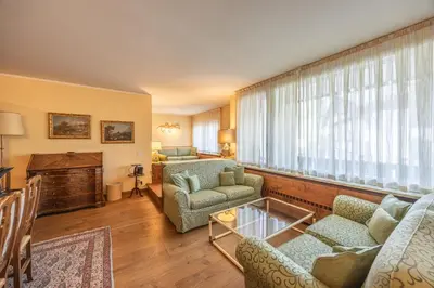 a living room with a couch and chairs and a window at Casa Sette, in centro a Cortina d Ampezzo in Cortina dʼAmpezzo